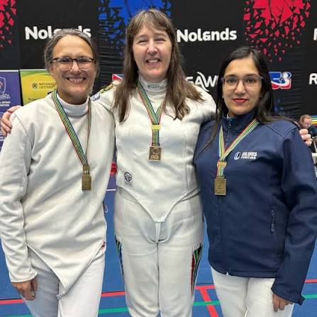 Three veteran women fencers on the podium with their medals