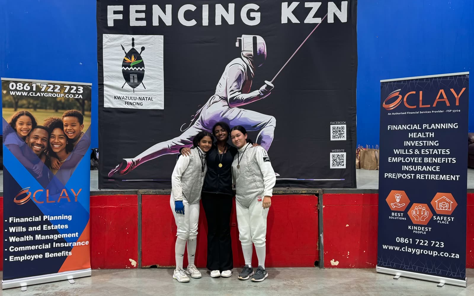 Young women fencers with medals in front of the Fencing KZN banner at Clay Group KZN Ranking 3