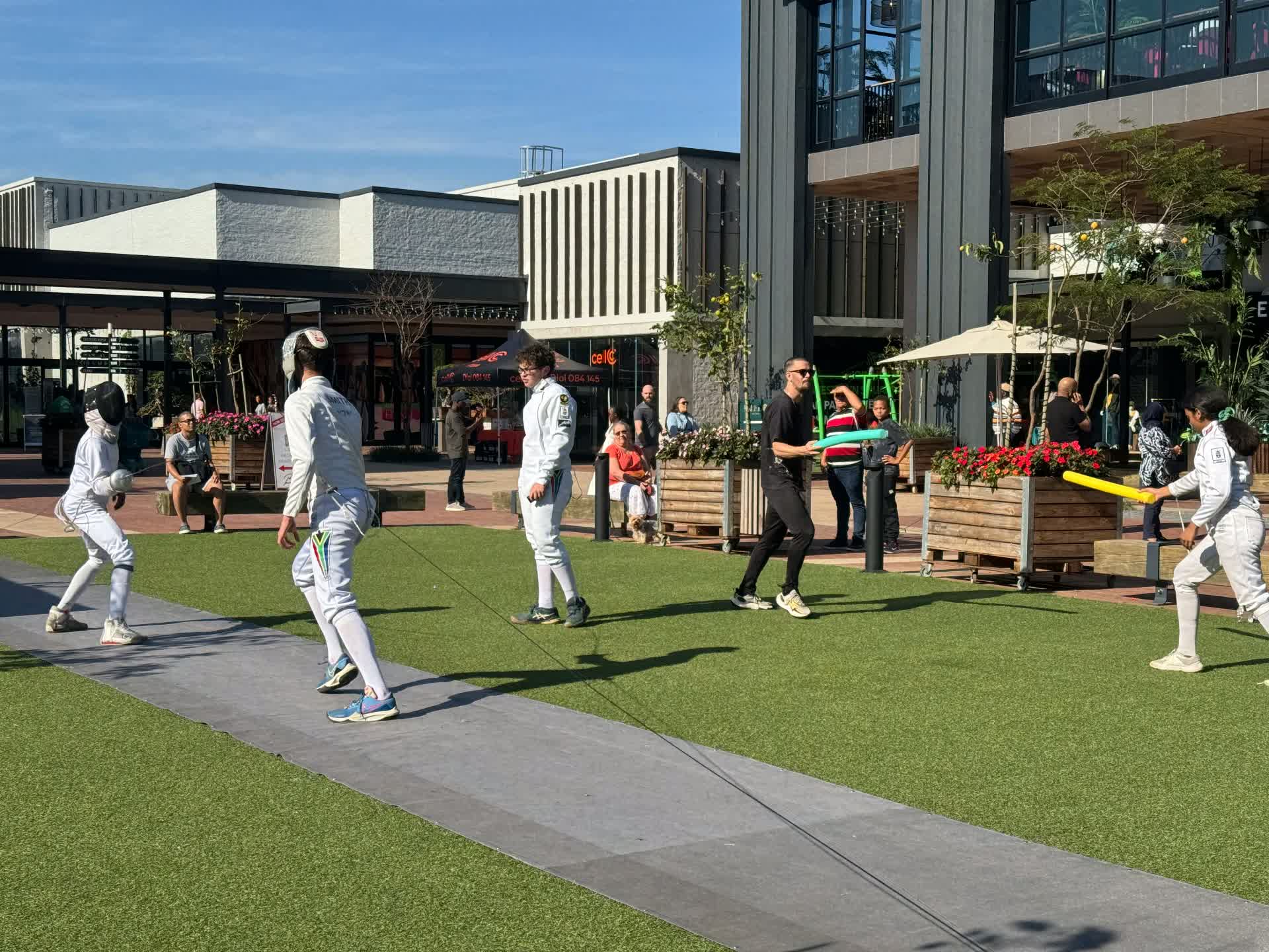 Children trying fencing with foam swords at a Fencing KZN public demonstration in Durban